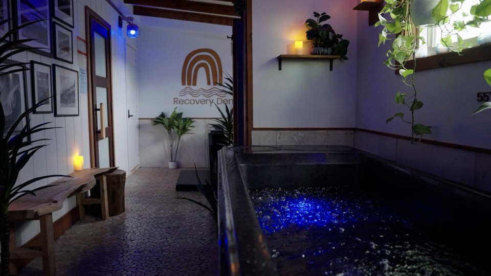The cold plunge at The Den Waialua, lit blue, with the 55 degree marker on the wall