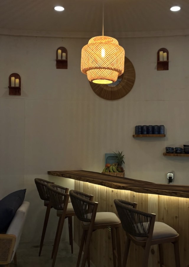 The Health Bar counter and stools in the Waialua lobby, lit warm in the evening