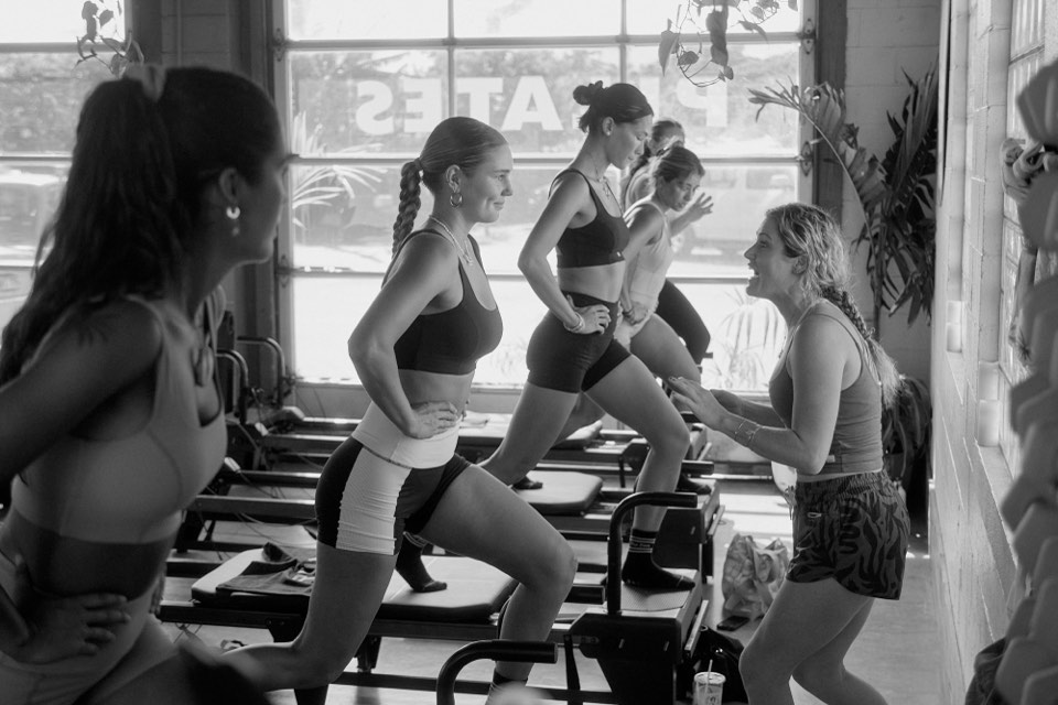 A row of reformers mid-lunge during the RVCA shoot