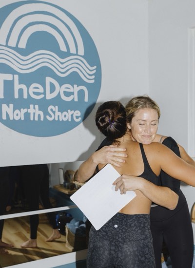 Chelsey and a graduate holding on to each other, her certificate still in hand